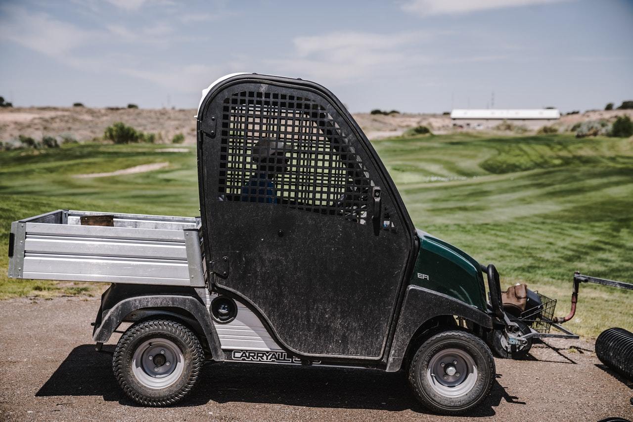 Groundskeeper in a golf cart