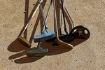 Image of golf putters from old to current